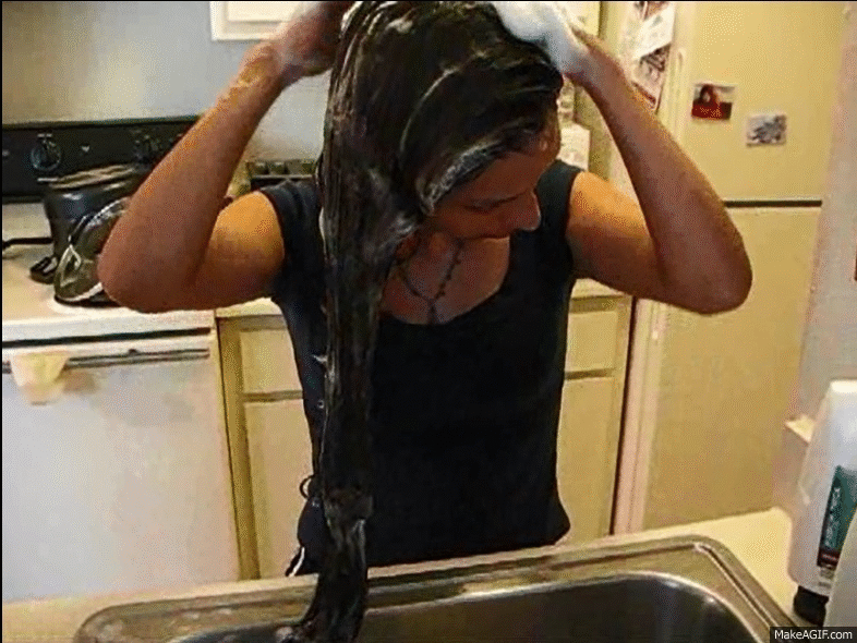 Housewife washes hair kitchen sink