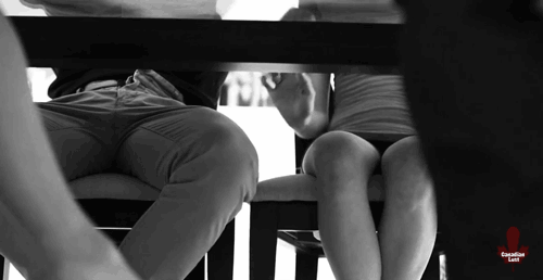 Feet teasing under table