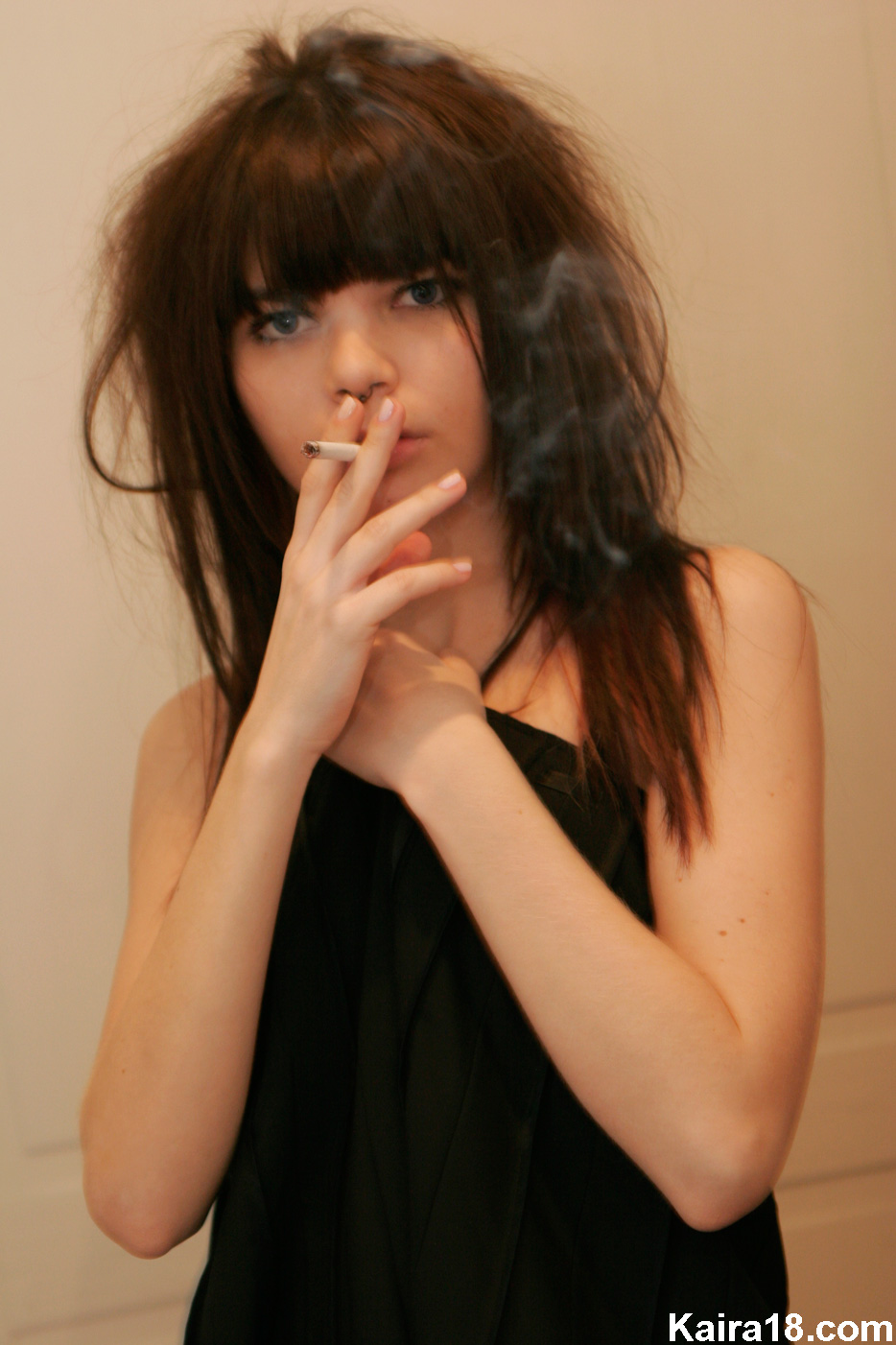 Bald punk girl smokes back cigarettes