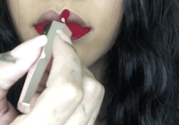 Pretty hispanic latina woman smoking lipstick